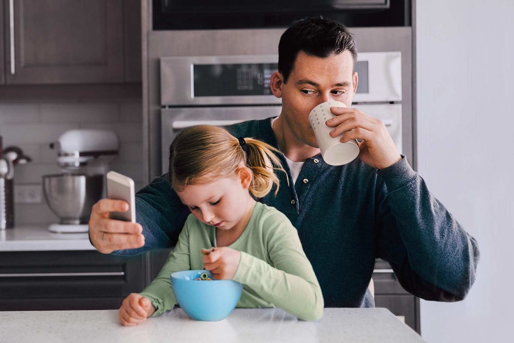 Man with kid checking mobile