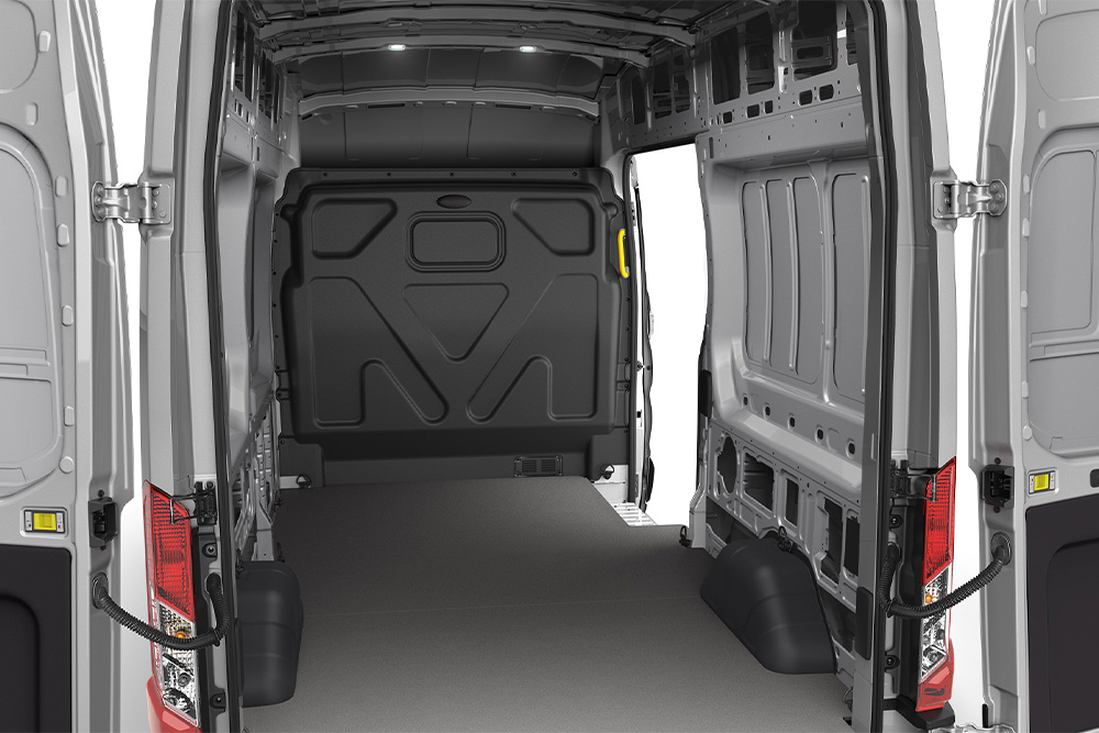 Interior view of an empty cargo area of a Ford Transit Van.